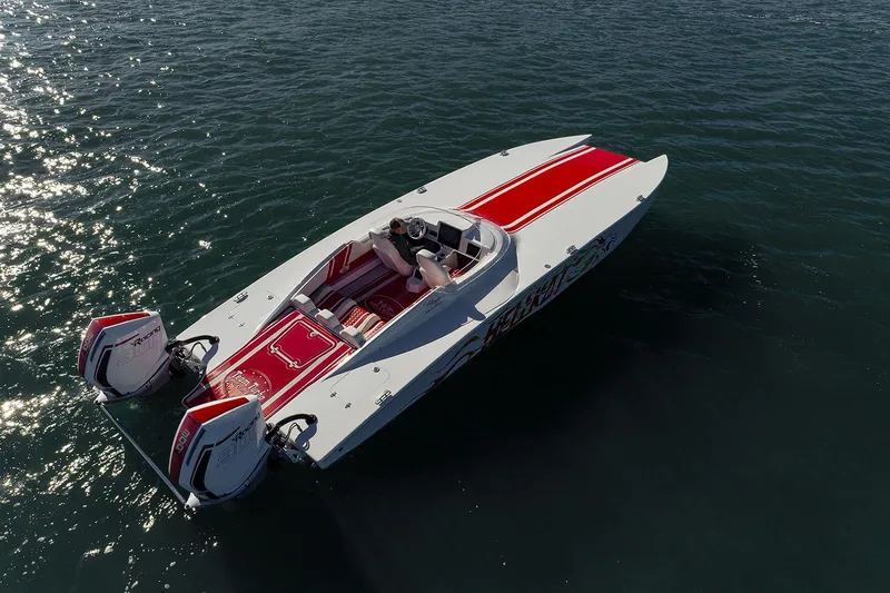  Yacht Photos Pics Aerial view of 2022 HellKats 32 speedboat with red accents on water.