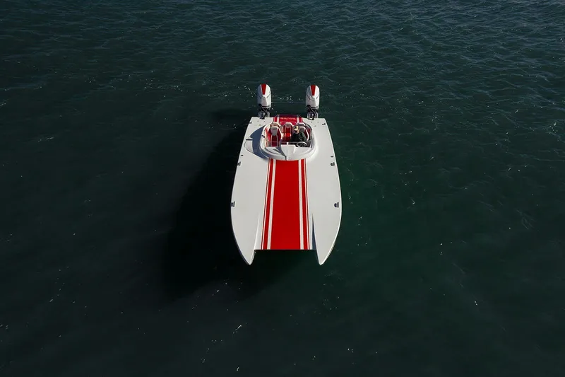  Yacht Photos Pics 2022 HellKats 32 powerboat with red stripe on open water.