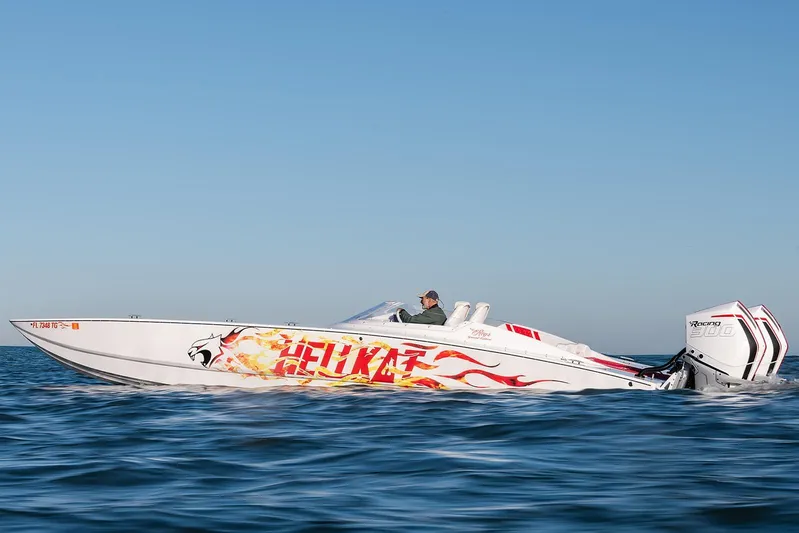  Yacht Photos Pics 2022 HellKats 32 speedboat with vibrant graphics cruising on open water.