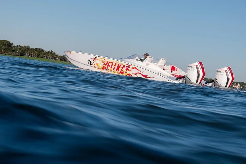  Yacht Photos Pics 2022 HellKats 32 speedboat with vibrant graphics cruising on open water.