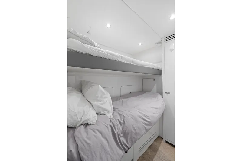  Yacht Photos Pics Bunk beds in a 2022 Princess Y85 yacht cabin, featuring modern white decor.