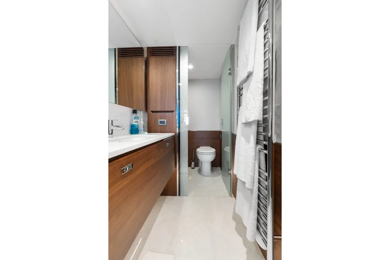  Yacht Photos Pics Luxurious bathroom in 2022 Princess Y85 yacht with modern wood cabinetry and sleek fixtures.