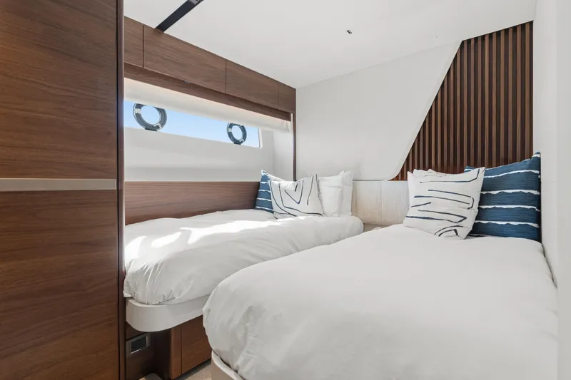  Yacht Photos Pics Luxurious 2022 Princess Y85 yacht cabin with twin beds and modern wood accents.