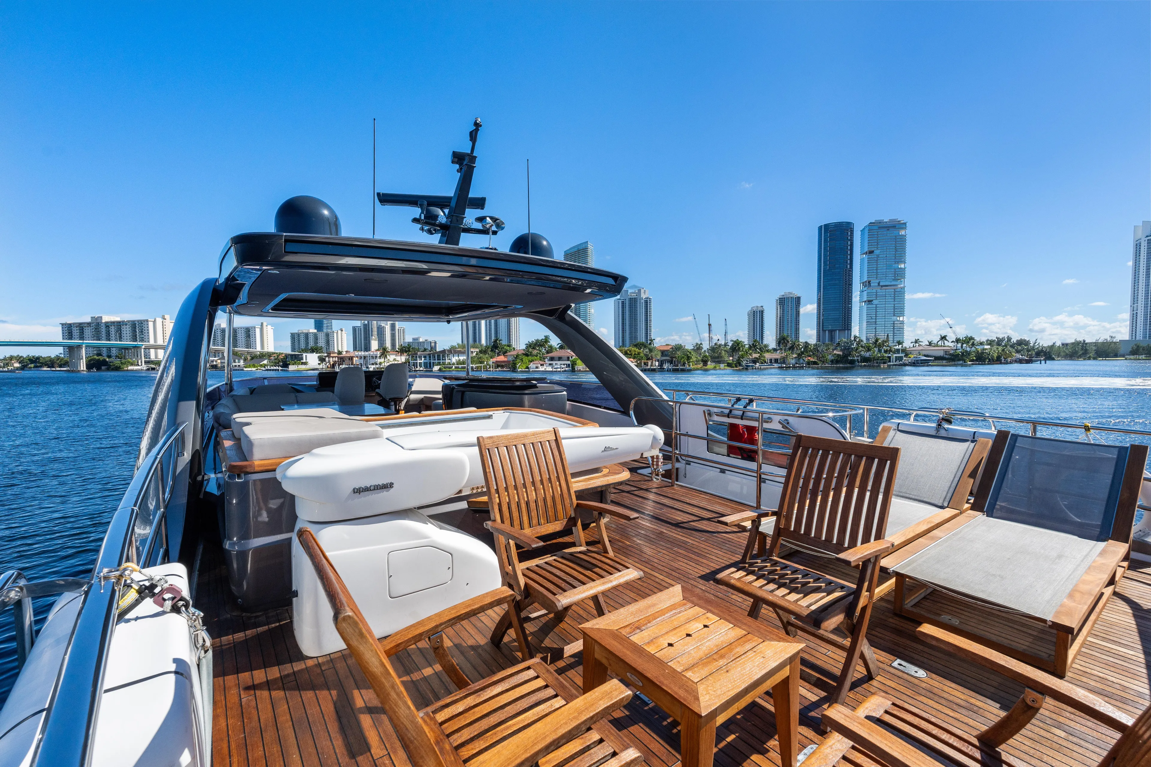  Yacht Photos Pics Luxurious 2022 Princess Y85 yacht deck with city skyline view, featuring elegant wooden seating.