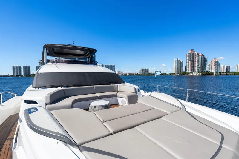  Yacht Photos Pics Luxurious 2022 Princess Y85 yacht with spacious deck, city skyline in background.