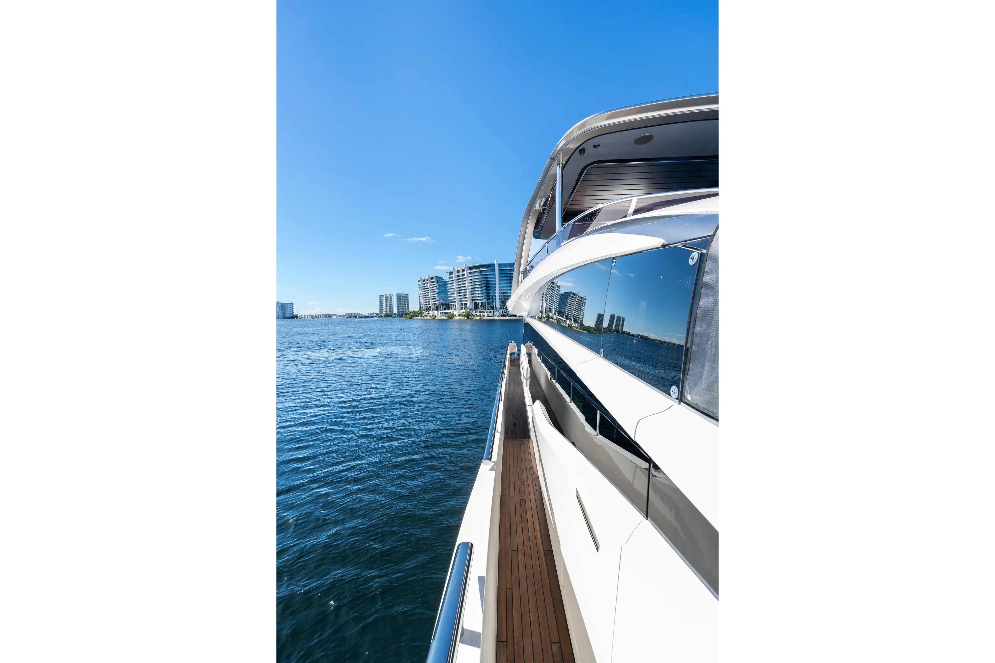  Yacht Photos Pics 2022 Princess Y85 yacht cruising near modern city skyline on a sunny day.