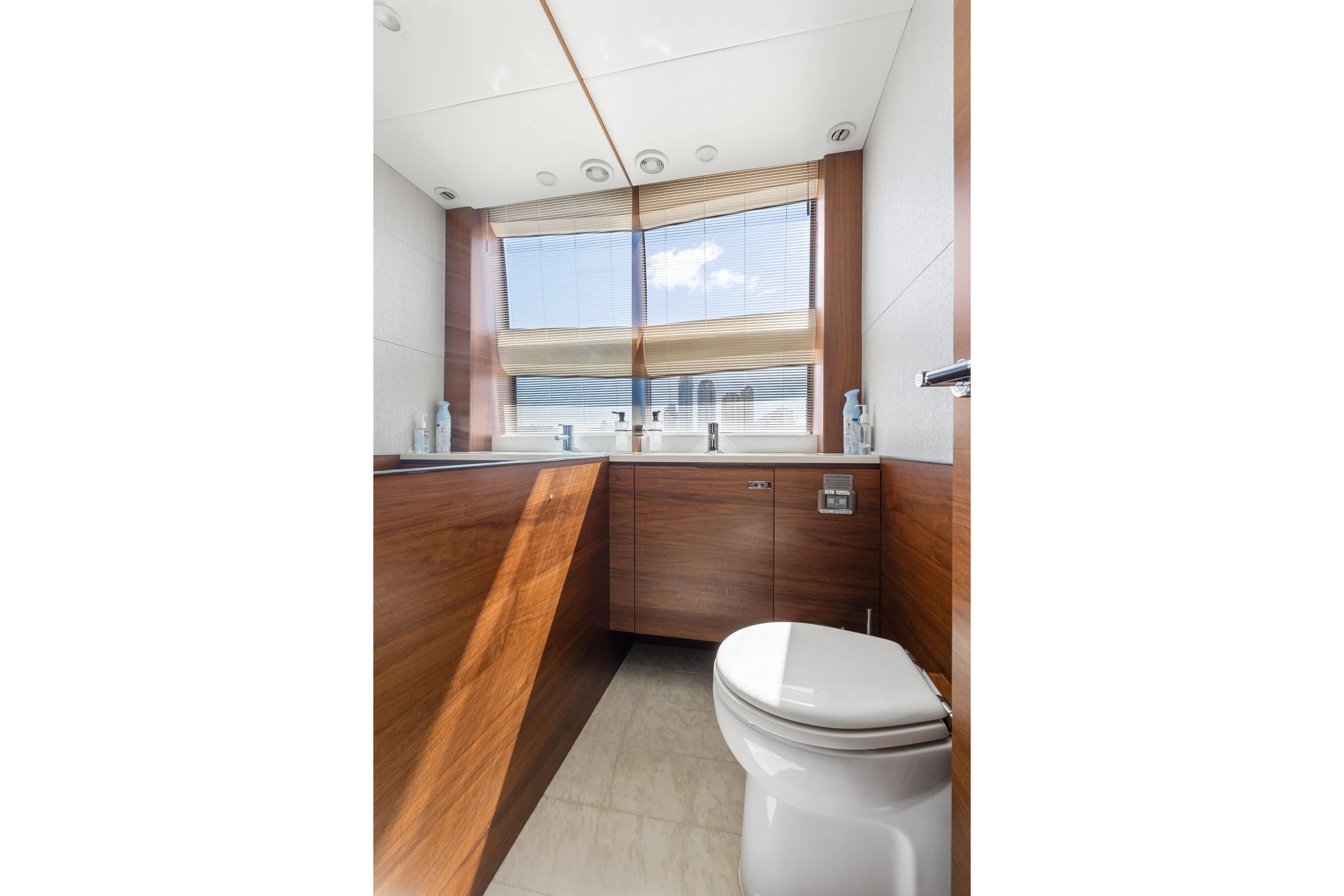  Yacht Photos Pics Luxurious bathroom in 2022 Princess Y85 yacht with modern wood finishes and large window.