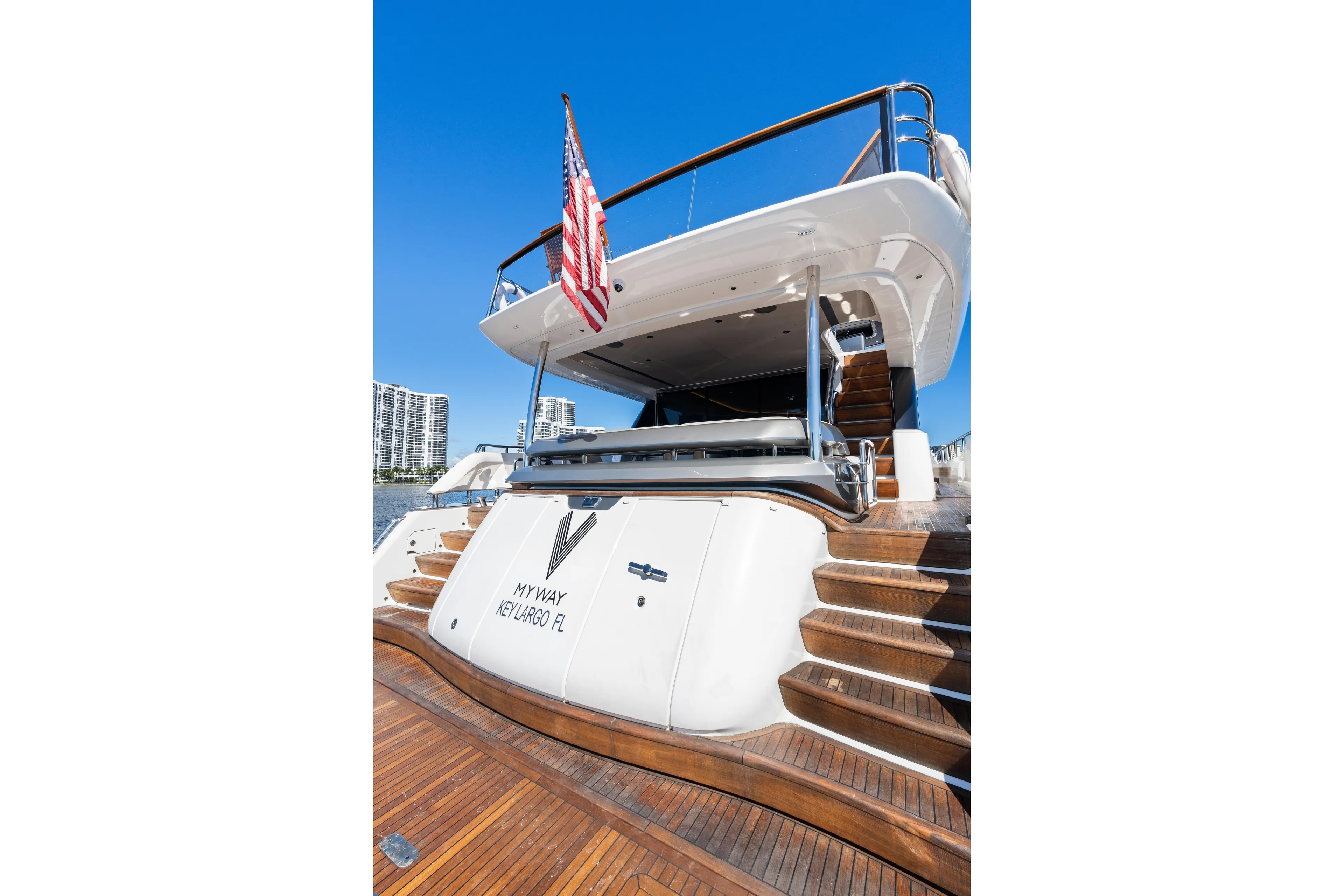  Yacht Photos Pics Luxury 2022 Princess Y85 yacht docked, featuring elegant wooden steps and American flag.