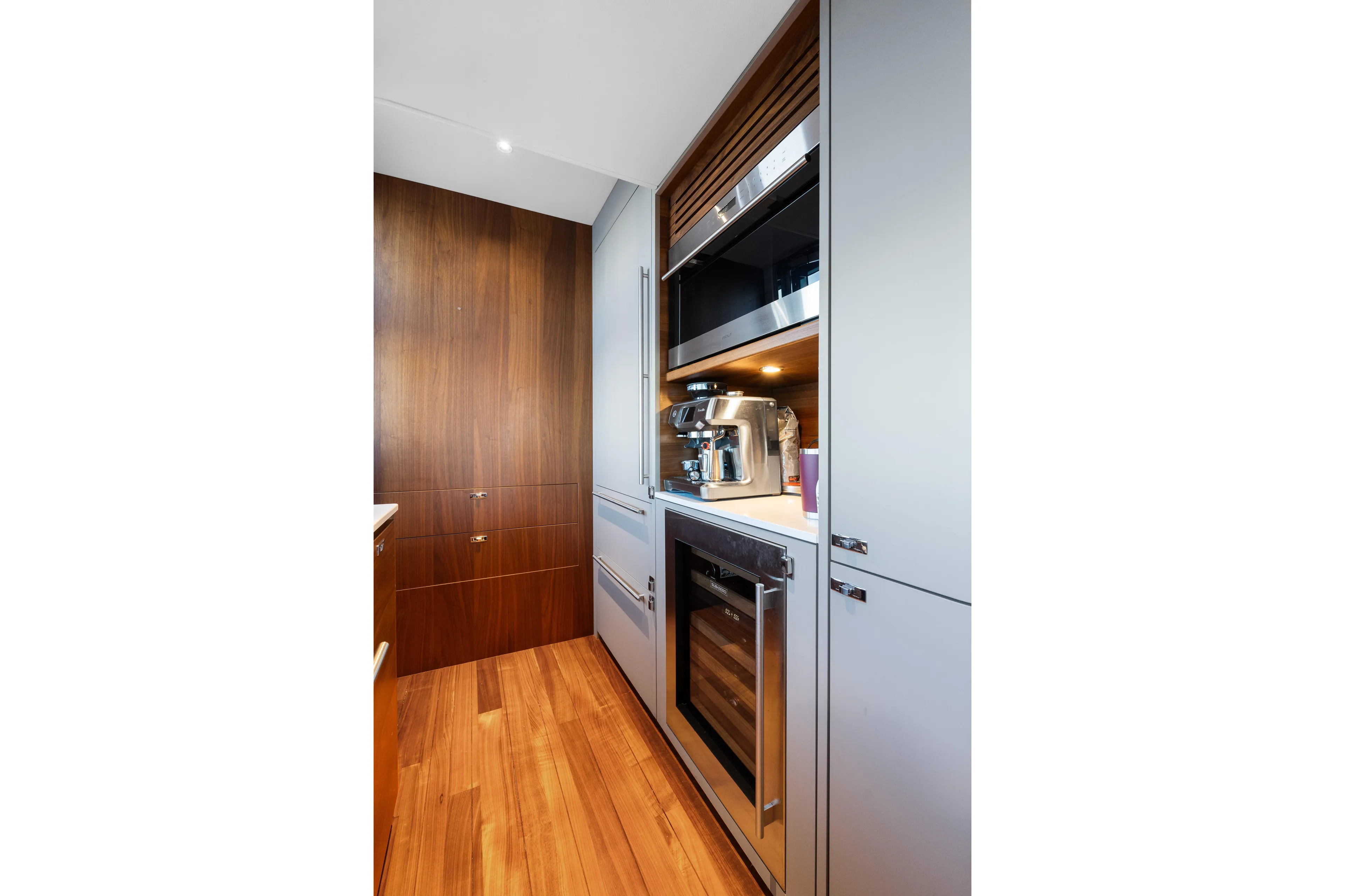  Yacht Photos Pics Modern kitchen in 2022 Princess Y85 yacht with sleek appliances and wooden accents.