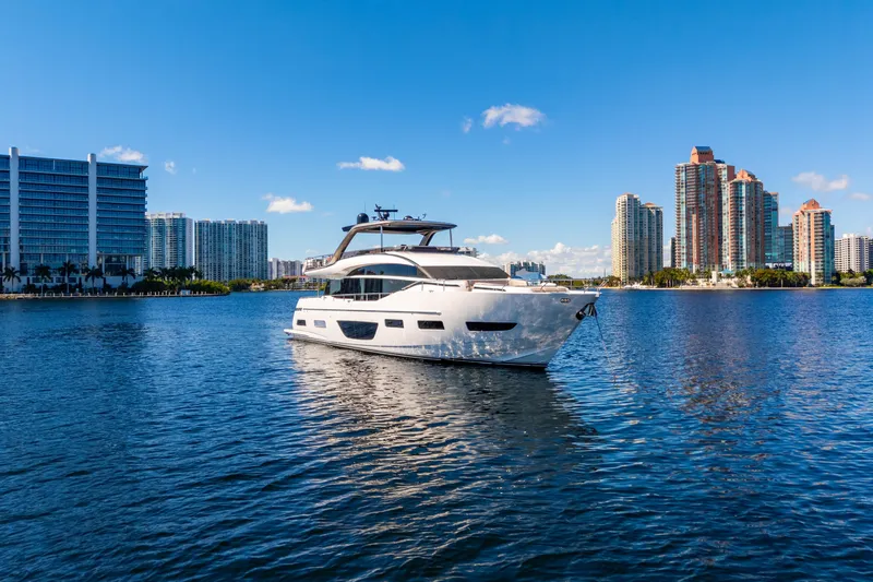  Yacht Photos Pics Luxurious 2022 Princess Y85 yacht cruising near modern city skyline on a sunny day.