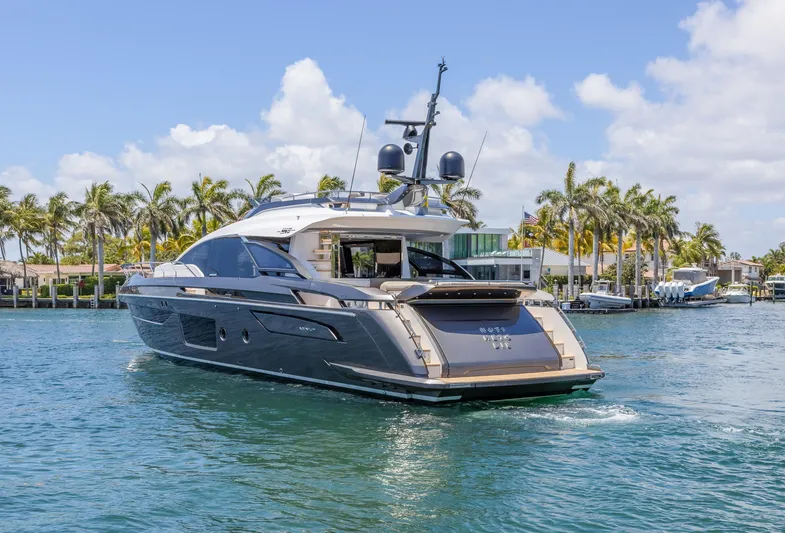 No Time To Die Yacht Photos Pics 2023 Azimut S8 yacht cruising on a sunny day with palm trees in the background.
