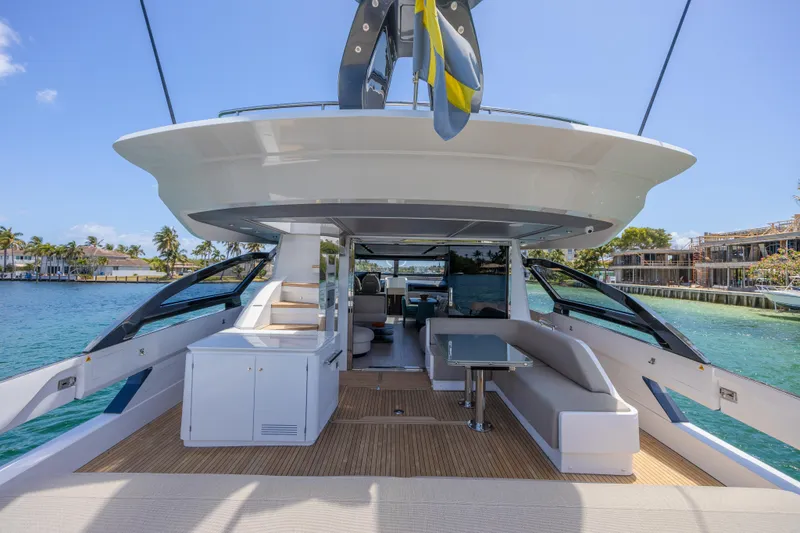 No Time To Die Yacht Photos Pics 2023 Azimut S8 yacht deck with seating, table, and ocean view.