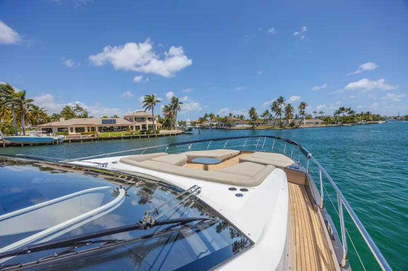 No Time To Die Yacht Photos Pics 2023 Azimut S8 yacht cruising on a sunny day with palm trees in the background.