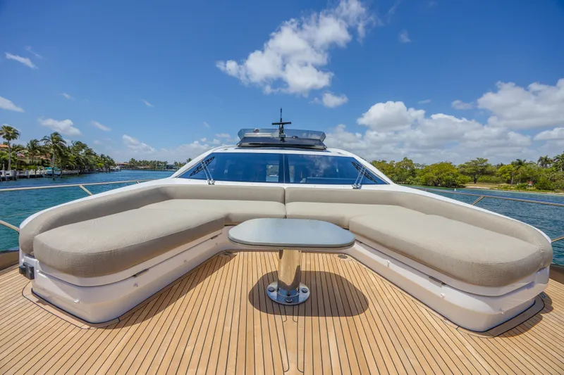 No Time To Die Yacht Photos Pics Luxurious 2023 Azimut S8 yacht deck with elegant seating and table, under a clear blue sky.