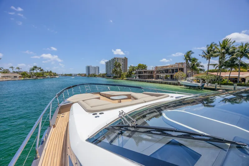 No Time To Die Yacht Photos Pics Luxurious 2023 Azimut S8 yacht cruising in a tropical waterfront setting.