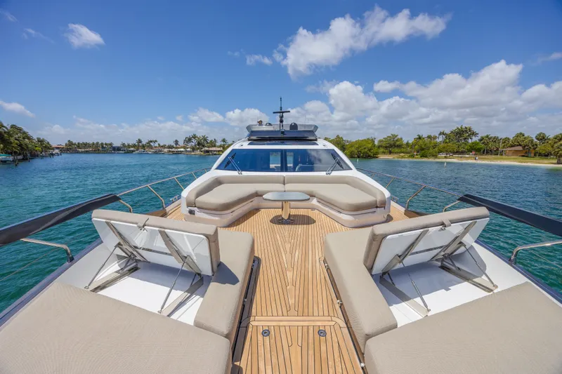 No Time To Die Yacht Photos Pics Luxurious 2023 Azimut S8 yacht deck with plush seating, cruising on clear blue waters.
