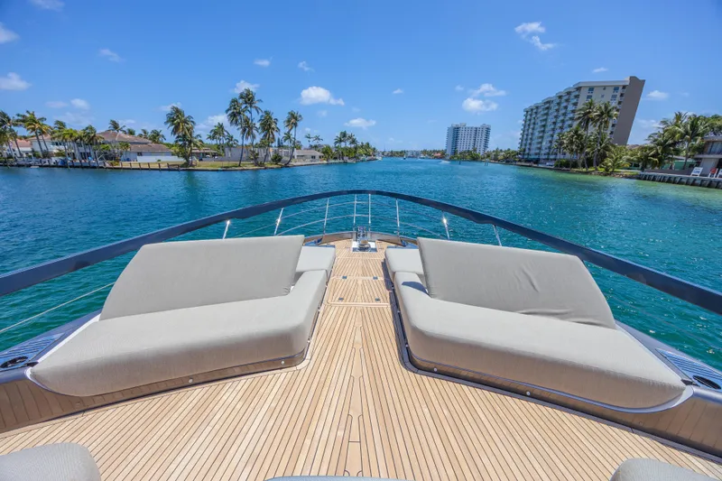 No Time To Die Yacht Photos Pics 2023 Azimut S8 yacht deck with luxurious seating, overlooking serene blue waters and palm trees.