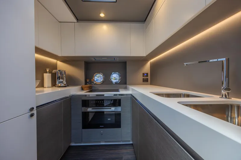 No Time To Die Yacht Photos Pics Modern kitchen interior of 2023 Azimut S8 yacht with sleek design and dual sinks.