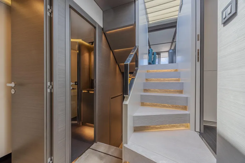 No Time To Die Yacht Photos Pics Luxurious interior of 2023 Azimut S8 yacht featuring modern staircase and elegant design.