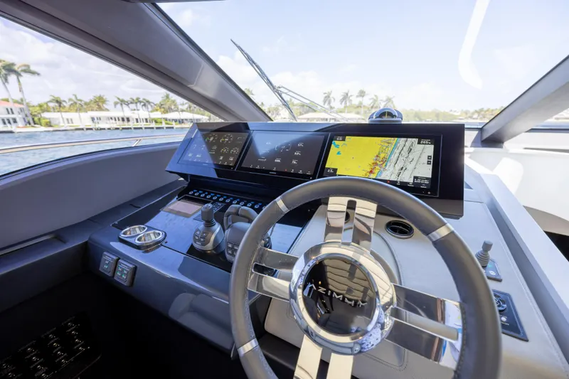 No Time To Die Yacht Photos Pics 2023 Azimut S8 yacht helm with advanced navigation displays and sleek steering wheel design.