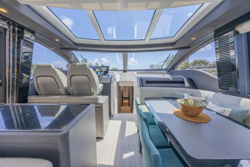 No Time To Die Yacht Photos Pics Luxurious interior of 2023 Azimut S8 yacht with panoramic windows and modern seating.