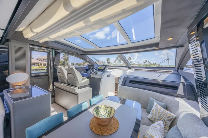 No Time To Die Yacht Photos Pics Luxurious interior of 2023 Azimut S8 yacht with modern seating and panoramic windows.