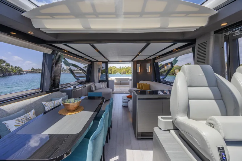 No Time To Die Yacht Photos Pics Luxurious interior of 2023 Azimut S8 yacht with modern seating and panoramic windows.