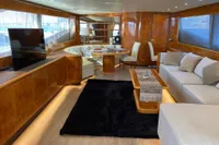 Luxurious interior of a 2004 Leopard 26 Flybridge yacht with elegant wood finishes and modern furnishings.