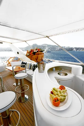  Yacht Photos Pics Luxurious 2004 Leopard 26 Flybridge yacht with elegant bar and ocean view.