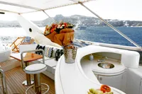 Luxurious 2004 Leopard 26 Flybridge yacht with elegant bar and ocean view.