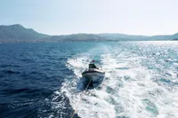 Leopard 26 Flybridge 2004 towing a small boat on open sea.