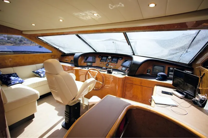  Yacht Photos Pics Luxurious interior of 2004 Leopard 26 Flybridge yacht with helm and seating area.