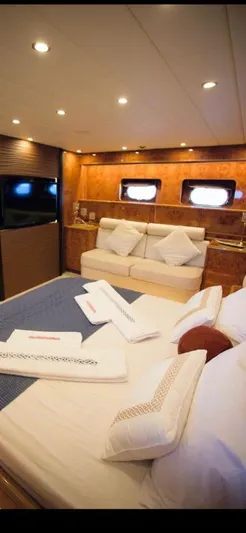  Yacht Photos Pics Luxurious interior of a 2004 Leopard 26 Flybridge yacht with elegant bedding and ambient lighting.