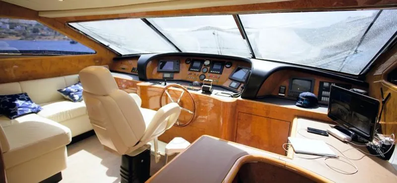  Yacht Photos Pics Luxurious interior of a 2004 Leopard 26 Flybridge yacht with modern helm and seating area.