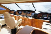 Luxurious interior of a 2004 Leopard 26 Flybridge yacht with modern helm and seating area.