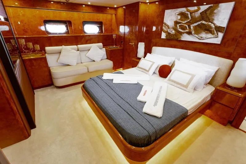  Yacht Photos Pics Luxurious bedroom interior on 2004 Leopard 26 Flybridge yacht with elegant decor and cozy bedding.