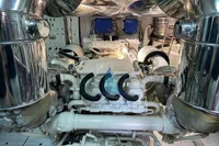 Engine room of a 2004 Leopard 26 Flybridge yacht, featuring polished metal components.