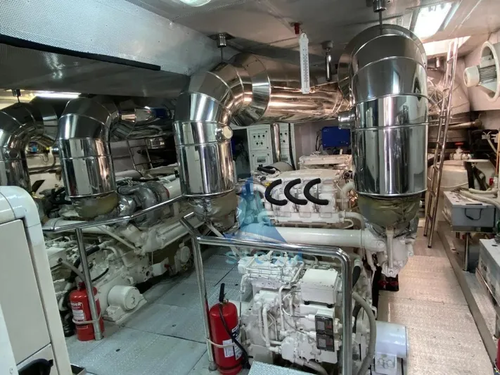  Yacht Photos Pics Engine room of a 2004 Leopard 26 Flybridge yacht, featuring dual engines and polished exhaust systems.