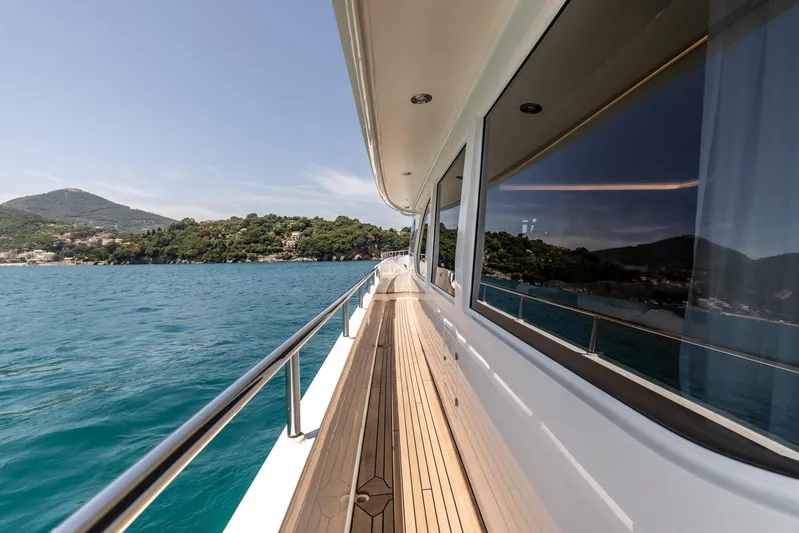 Jasmine Luna Yacht Photos Pics Side deck view of 2007 Moonen JASMINE LUNA yacht cruising near scenic coastline.