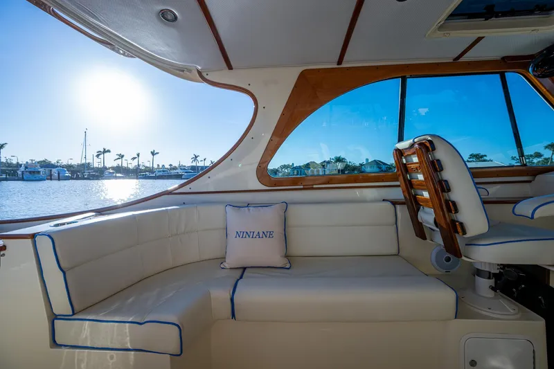 Niniane Yacht Photos Pics Interior of 2016 Hinckley Talaria 34 yacht with sunlit seating area and water view.