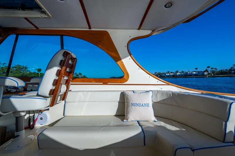 Niniane Yacht Photos Pics Interior of 2016 Hinckley Talaria 34 yacht with white seating and scenic water view.