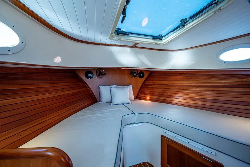 Niniane Yacht Photos Pics 2016 Hinckley Talaria 34 cabin interior with wood paneling and skylight.