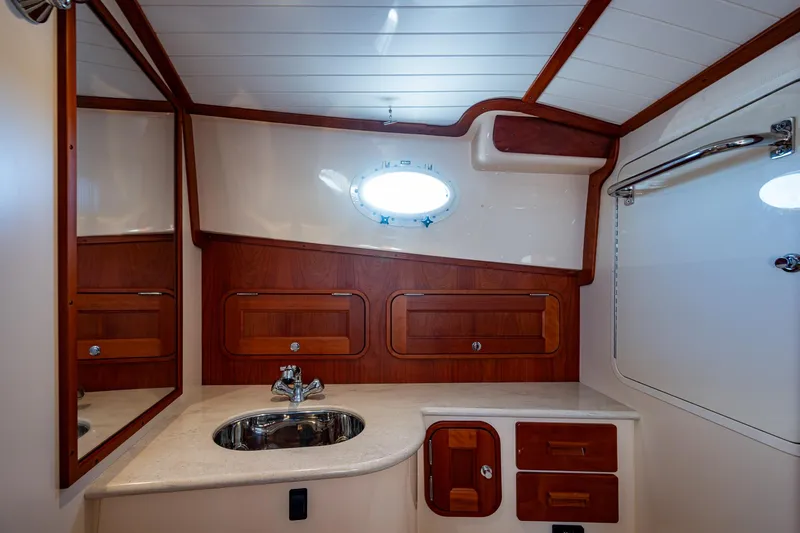 Niniane Yacht Photos Pics Luxurious 2016 Hinckley Talaria 34 yacht bathroom with elegant wood accents and modern fixtures.