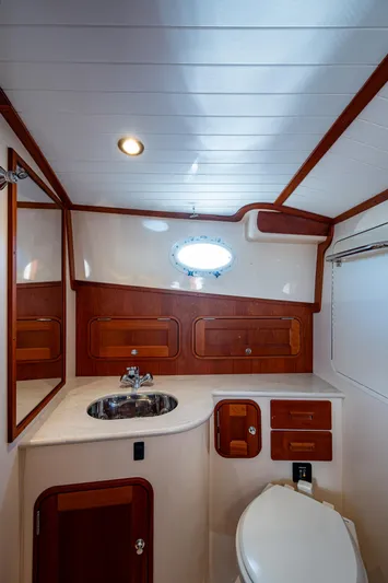 Niniane Yacht Photos Pics 2016 Hinckley Talaria 34 yacht bathroom with wood accents and modern fixtures.
