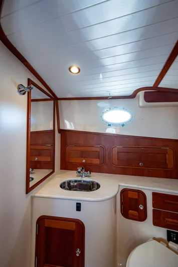 Niniane Yacht Photos Pics 2016 Hinckley Talaria 34 yacht bathroom with wood accents and modern fixtures.