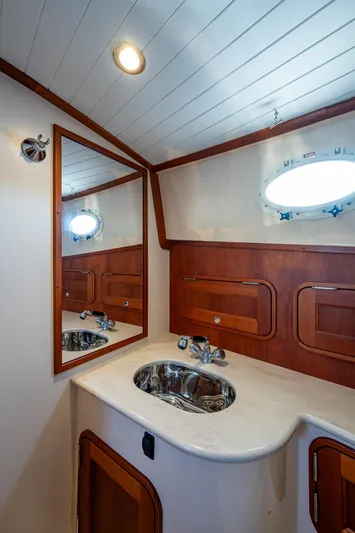Niniane Yacht Photos Pics 2016 Hinckley Talaria 34 yacht bathroom with wooden accents and stainless steel sink.