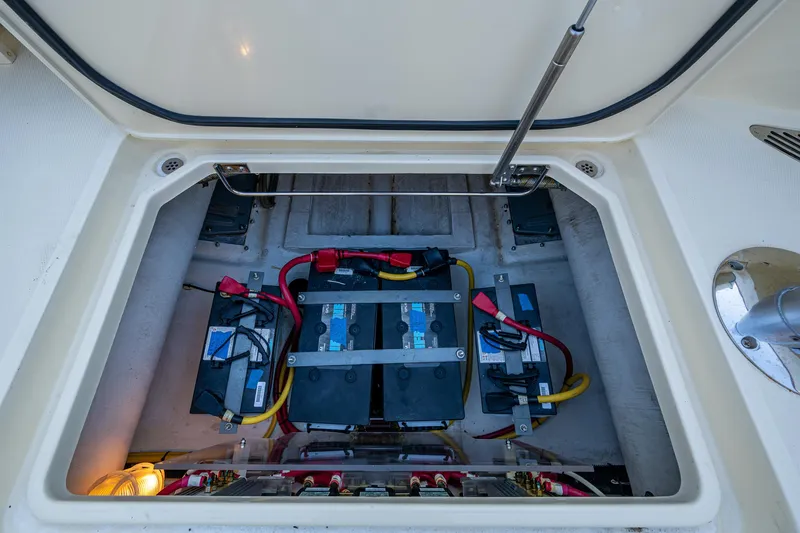 Niniane Yacht Photos Pics Battery compartment of a 2016 Hinckley Talaria 34 boat, showing multiple batteries and wiring.