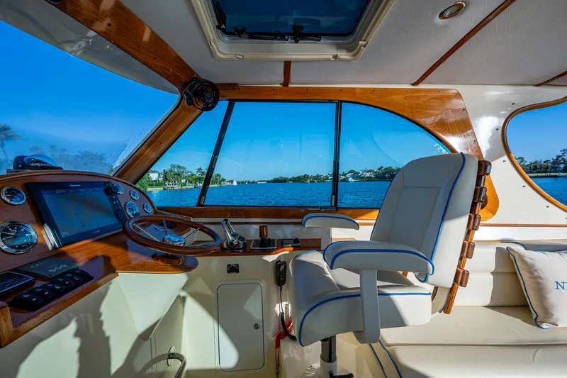 Niniane Yacht Photos Pics Interior of 2016 Hinckley Talaria 34 yacht with helm and seating, overlooking water.