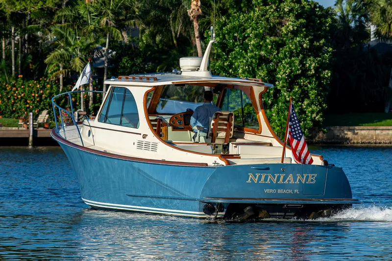 Niniane Yacht Photos Pics 2016 Hinckley Talaria 34 boat cruising on a sunny day, displaying an American flag.