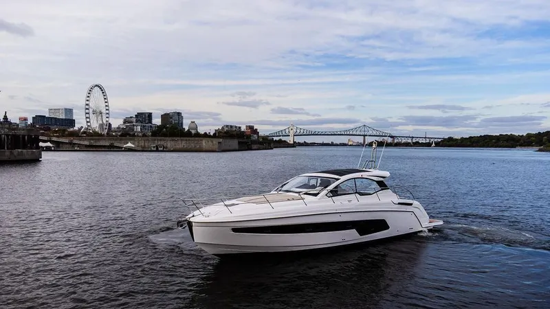  Yacht Photos Pics 2025 Azimut Atlantis 45 yacht cruising on a scenic river with cityscape background.